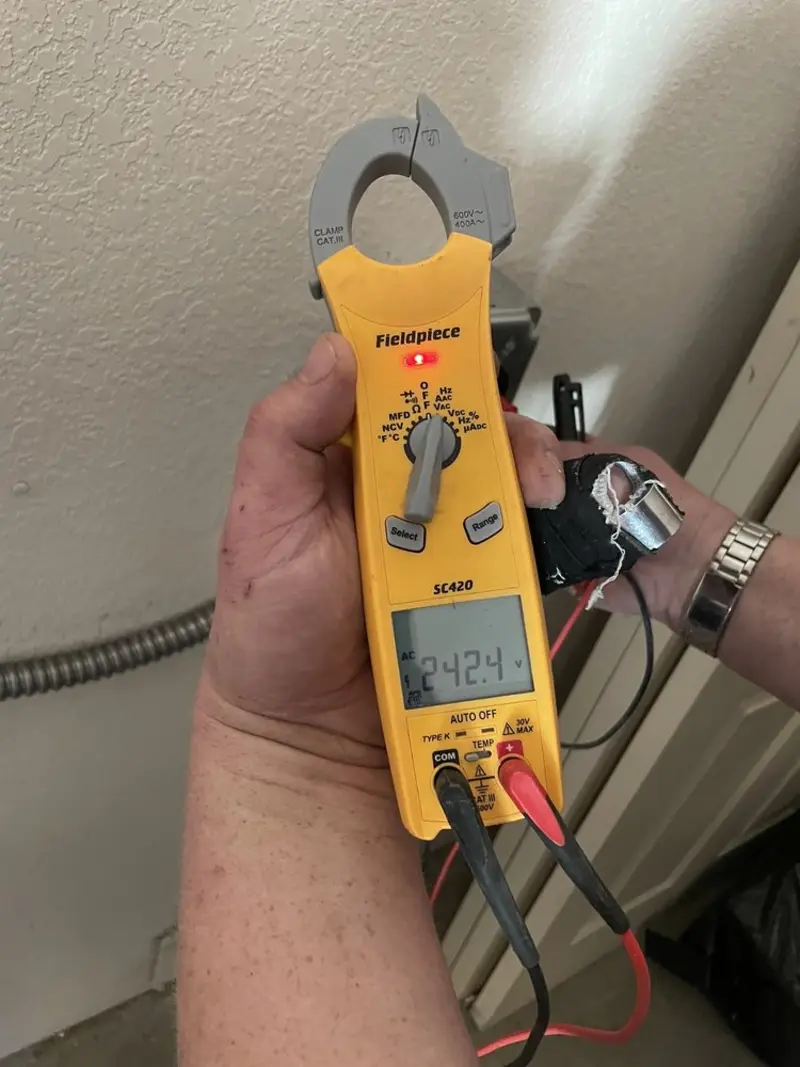 Voltage testing with clamp meter during Outlet Installation in Pine Hills